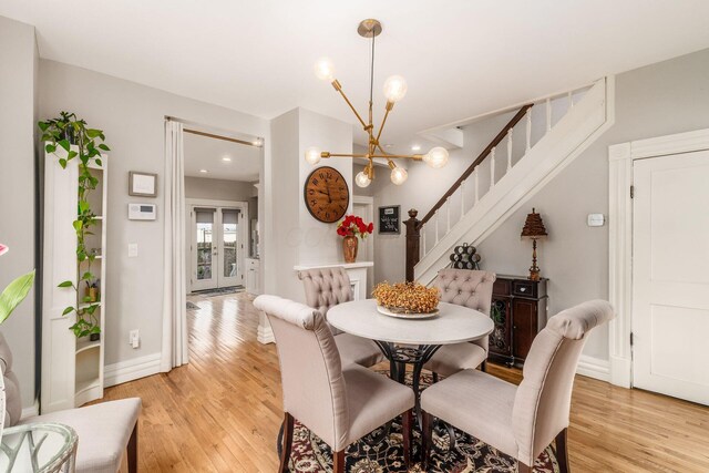 1105 Say Ave, Columbus, OH 43201 - dining room with a chandelier, light wood-type flooring, stairway, baseboards, and recessed lighting