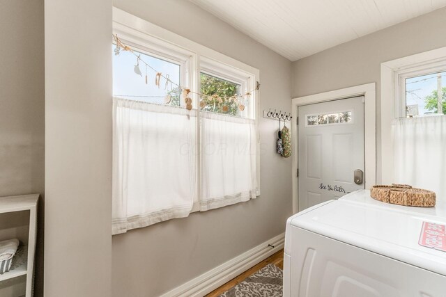 1105 Say Ave, Columbus, OH 43201 - laundry area with washer / dryer, wood finished floors, and baseboards