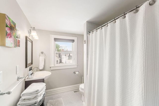 1105 Say Ave, Columbus, OH 43201 - full bath with tile patterned floors, vanity, toilet, baseboards, and a shower with shower curtain