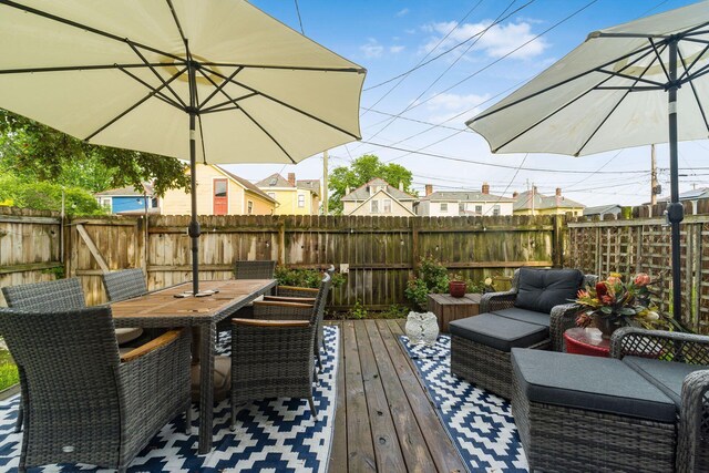 1105 Say Ave, Columbus, OH 43201 - wooden deck featuring a fenced backyard, outdoor dining space, and an outdoor hangout area