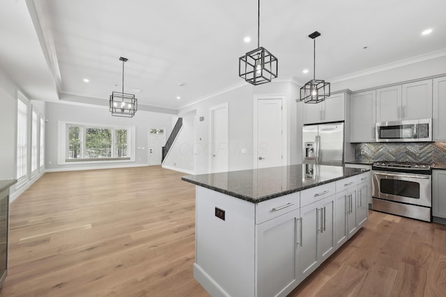 268 E Gay St Unit Th38, Columbus, OH 43215 - kitchen with appliances with stainless steel finishes, a chandelier, decorative backsplash, light wood-type flooring, and recessed lighting