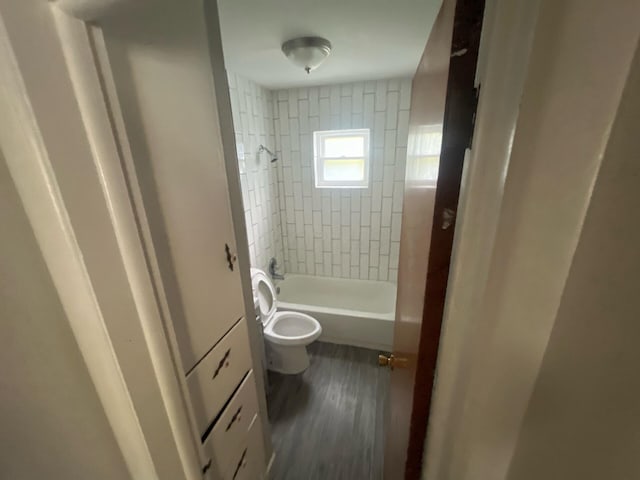 1227 Hart Rd, Columbus, OH 43223 - bathroom with toilet, washtub / shower combination, and wood finished floors