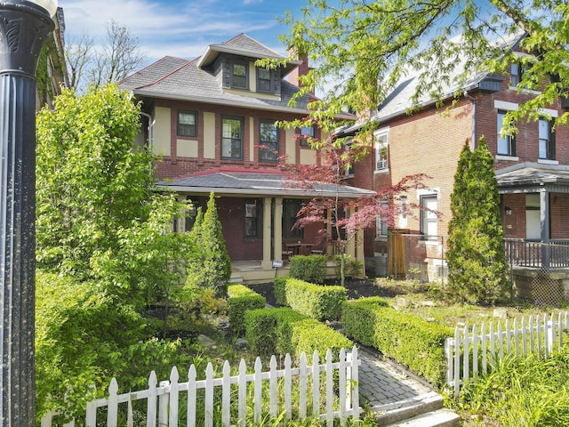 1041 Franklin Ave, Columbus, OH 43205 - view of front facade with brick siding, fence, and a porch