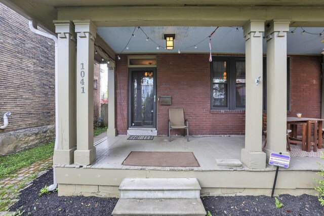 1041 Franklin Ave, Columbus, OH 43205 - view of exterior entry featuring a porch and brick siding
