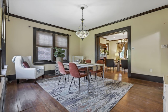 1041 Franklin Ave, Columbus, OH 43205 - dining space featuring ornamental molding, a chandelier, hardwood / wood-style flooring, and baseboards