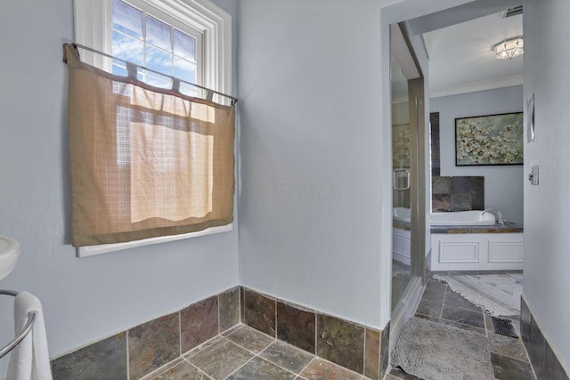 1041 Franklin Ave, Columbus, OH 43205 - full bath featuring stone tile floors, a stall shower, a garden tub, ornamental molding, and baseboards