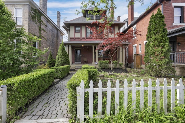 1041 Franklin Ave, Columbus, OH 43205 - tudor-style house featuring covered porch and a fenced front yard