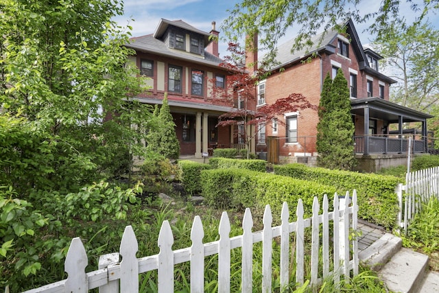 1041 Franklin Ave, Columbus, OH 43205 - view of front of home with brick siding, a chimney, and covered porch