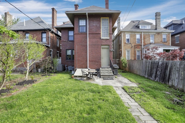 1041 Franklin Ave, Columbus, OH 43205 - rear view of property with brick siding, cooling unit, and a chimney