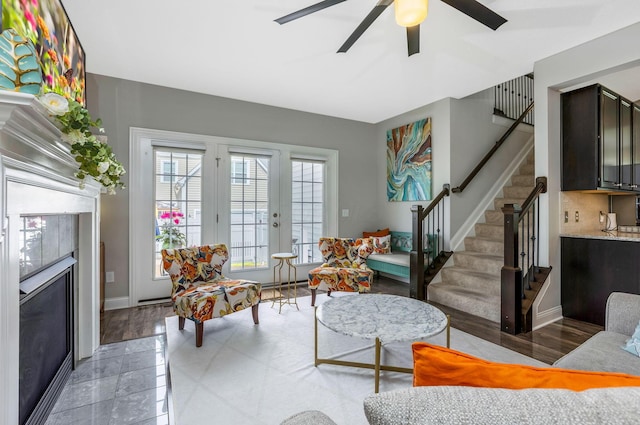 5119 Butterworth Green Dr, New Albany, OH 43054 - living area featuring stairway, ceiling fan, a fireplace, and baseboards