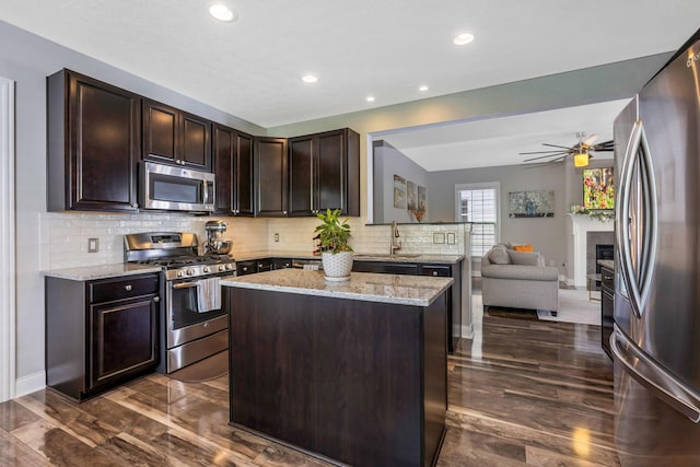 5119 Butterworth Green Dr, New Albany, OH 43054 - kitchen with appliances with stainless steel finishes, a sink, open floor plan, light stone counters, and recessed lighting