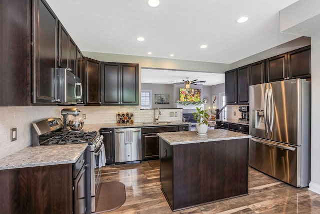 5119 Butterworth Green Dr, New Albany, OH 43054 - kitchen featuring appliances with stainless steel finishes, a sink, dark brown cabinetry, dark wood finished floors, and recessed lighting