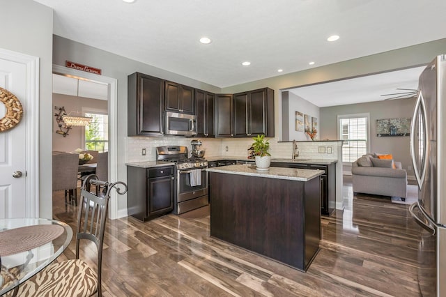 5119 Butterworth Green Dr, New Albany, OH 43054 - kitchen with stainless steel appliances, dark brown cabinets, dark wood-style floors, plenty of natural light, and recessed lighting