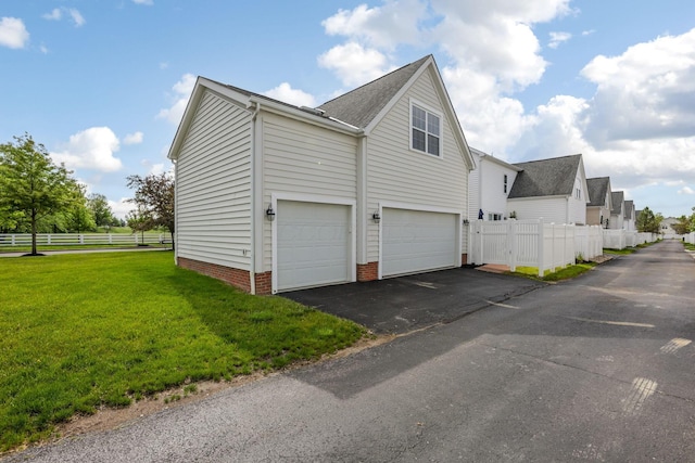 5119 Butterworth Green Dr, New Albany, OH 43054 - view of home's exterior with a garage, asphalt driveway, and roof with shingles
