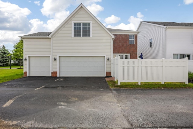 5119 Butterworth Green Dr, New Albany, OH 43054 - view of front of property featuring driveway, brick siding, fence, and a garage