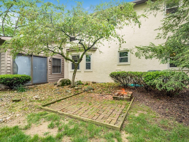 6079 Catawba Dr, Grove City, OH 43123 - rear view of property with stucco siding, a fire pit, and a patio
