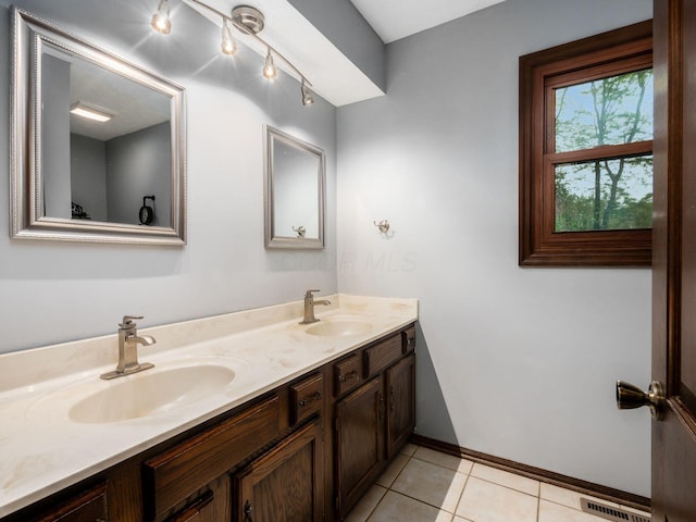 6079 Catawba Dr, Grove City, OH 43123 - bathroom featuring double vanity, baseboards, and tile patterned floors