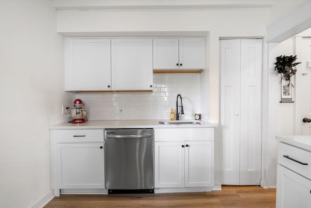 357 E Welch Ave, Columbus, OH 43207 - kitchen with dishwasher, backsplash, a sink, and white cabinetry