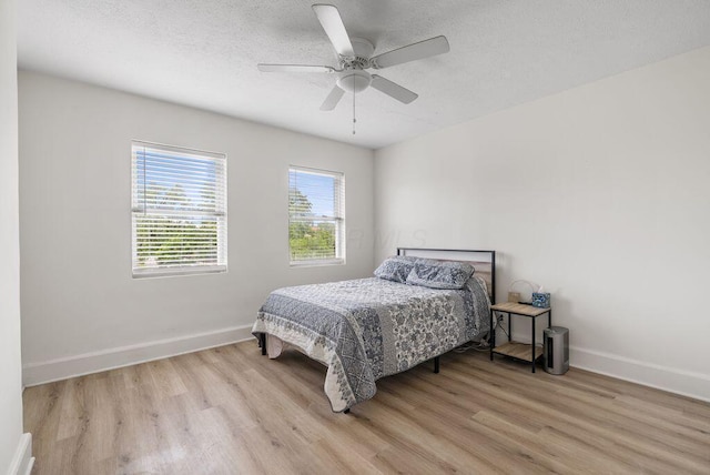 357 E Welch Ave, Columbus, OH 43207 - bedroom with wood finished floors, baseboards, ceiling fan, and a textured ceiling