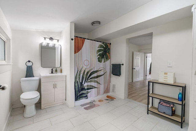 357 E Welch Ave, Columbus, OH 43207 - bathroom featuring toilet, vanity, baseboards, and tile patterned flooring