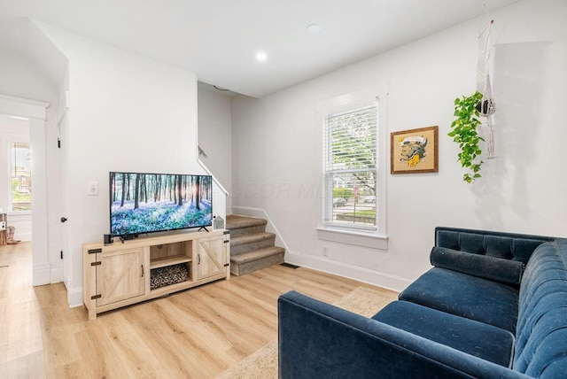 357 E Welch Ave, Columbus, OH 43207 - living room with stairs, light wood-type flooring, baseboards, and recessed lighting