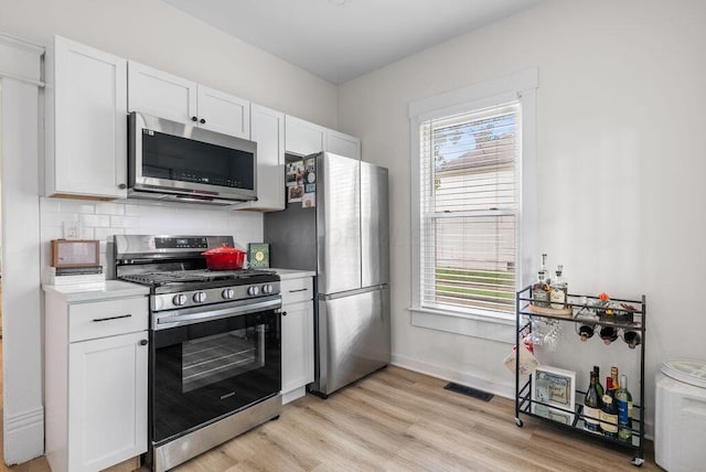 357 E Welch Ave, Columbus, OH 43207 - kitchen featuring stainless steel appliances, white cabinetry, light countertops, and plenty of natural light