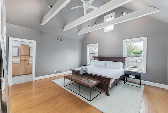 308 Jackson St, Columbus, OH 43206 - bedroom featuring high vaulted ceiling, light wood-type flooring, beam ceiling, baseboards, and ensuite bath