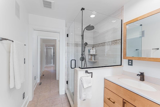 308 Jackson St, Columbus, OH 43206 - bathroom featuring tile patterned flooring, a stall shower, and vanity