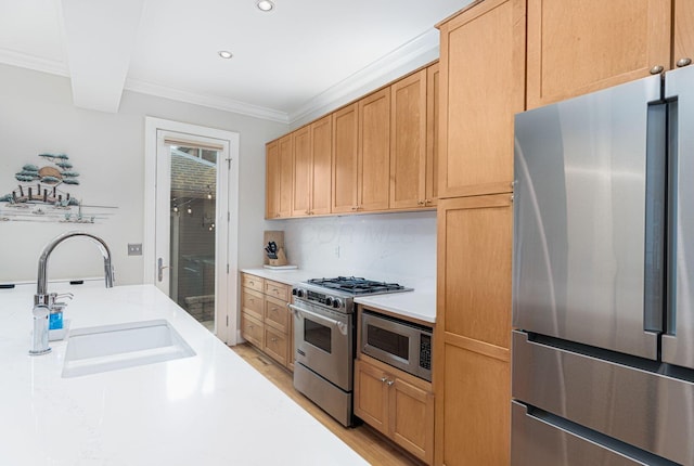 308 Jackson St, Columbus, OH 43206 - kitchen featuring stainless steel appliances, a sink, light countertops, crown molding, and recessed lighting