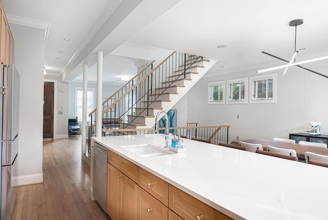 308 Jackson St, Columbus, OH 43206 - kitchen featuring a sink, appliances with stainless steel finishes, open floor plan, baseboards, and wood finished floors