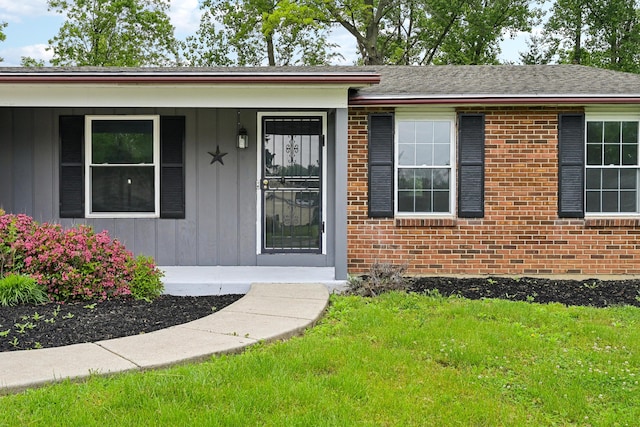 3368 Pine Valley Rd, Columbus, OH 43219 - entrance to property with brick siding, a lawn, a porch, and board and batten siding