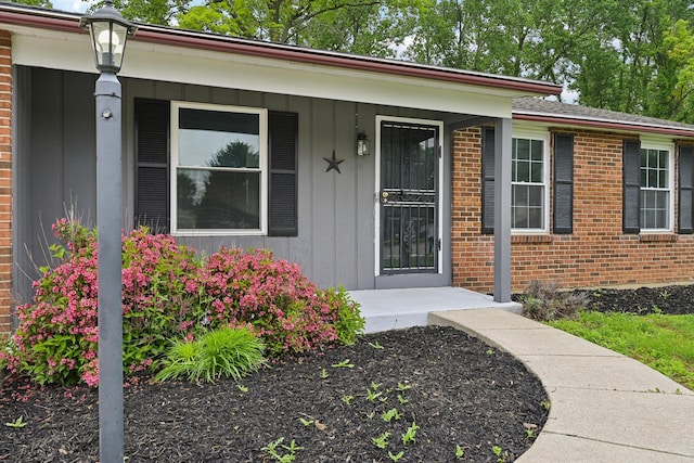 3368 Pine Valley Rd, Columbus, OH 43219 - property entrance featuring brick siding, a porch, and board and batten siding