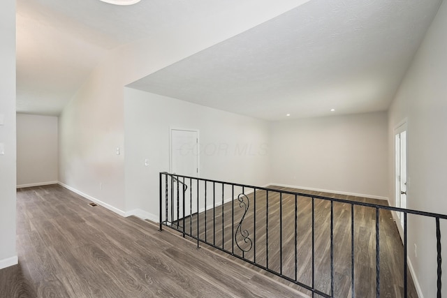 3368 Pine Valley Rd, Columbus, OH 43219 - hall featuring an upstairs landing, wood finished floors, baseboards, and lofted ceiling