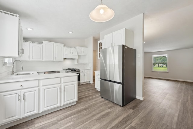 3368 Pine Valley Rd, Columbus, OH 43219 - kitchen featuring appliances with stainless steel finishes, a sink, light wood-style flooring, white cabinetry, and light countertops