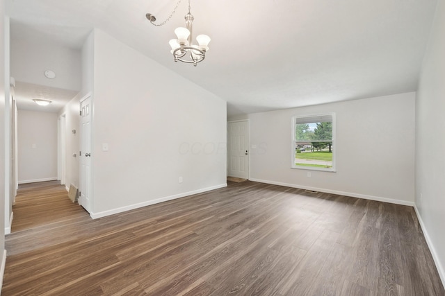 3368 Pine Valley Rd, Columbus, OH 43219 - spare room featuring dark wood-style flooring, baseboards, and a chandelier