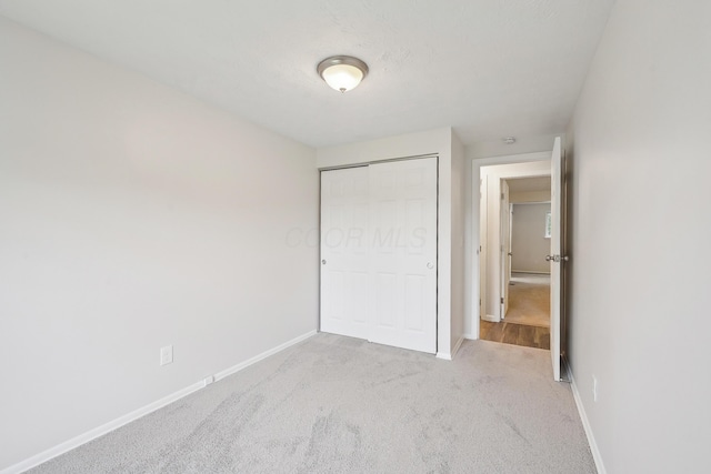 3368 Pine Valley Rd, Columbus, OH 43219 - unfurnished bedroom with a closet, baseboards, and carpet