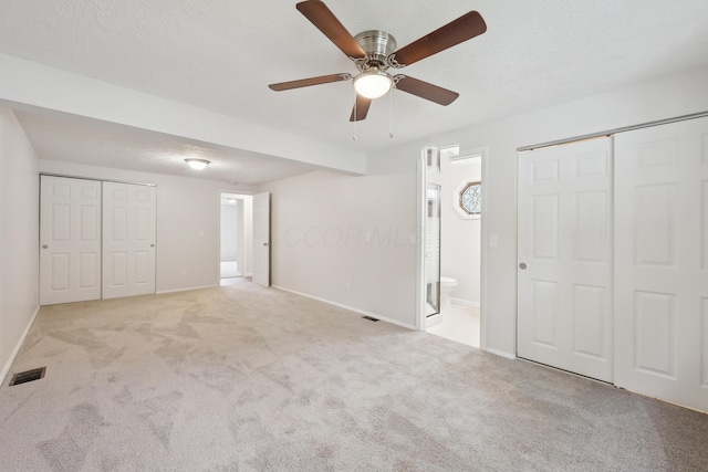 3368 Pine Valley Rd, Columbus, OH 43219 - unfurnished bedroom with carpet, baseboards, connected bathroom, and a ceiling fan