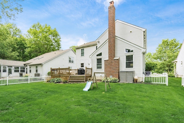 back of house featuring a deck and a chimney