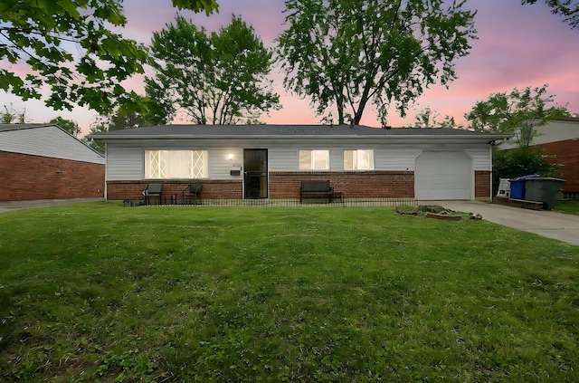 2894 Langfield Dr, Columbus, OH 43209 - ranch-style home with brick siding, an attached garage, a yard, and driveway