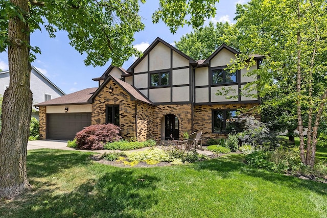 750 Pepper Ct, Westerville, OH 43082 - tudor home featuring stucco siding, a front lawn, a garage, and brick siding