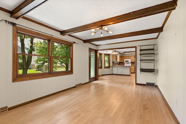 750 Pepper Ct, Westerville, OH 43082 - unfurnished living room featuring a chandelier, light wood-type flooring, beam ceiling, plenty of natural light, and wood walls