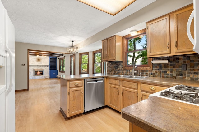 750 Pepper Ct, Westerville, OH 43082 - kitchen featuring dishwasher, a peninsula, light wood-style flooring, tasteful backsplash, and white fridge with ice dispenser