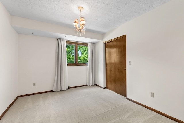 750 Pepper Ct, Westerville, OH 43082 - unfurnished room with a chandelier, light carpet, and a textured ceiling