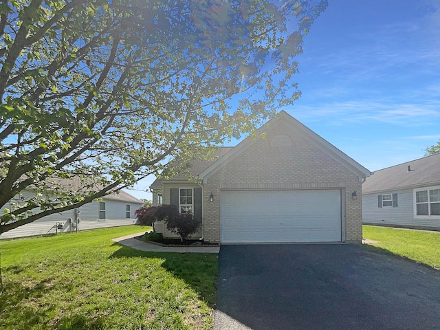 3118 Legion Ln, Columbus, OH 43232 - view of front facade featuring brick siding, asphalt driveway, an attached garage, and a front lawn