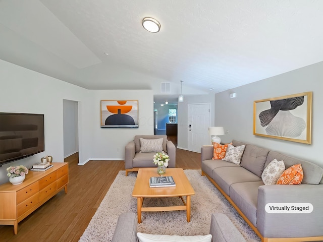 3118 Legion Ln, Columbus, OH 43232 - living room with vaulted ceiling, wood finished floors, and baseboards