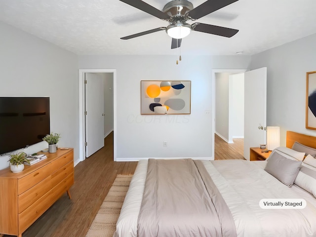3118 Legion Ln, Columbus, OH 43232 - bedroom featuring wood finished floors, baseboards, ceiling fan, and radiator