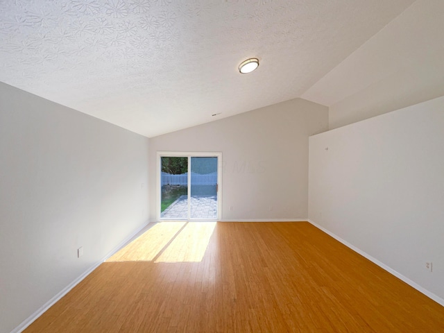 3118 Legion Ln, Columbus, OH 43232 - spare room with wood finished floors, lofted ceiling, baseboards, and a textured ceiling