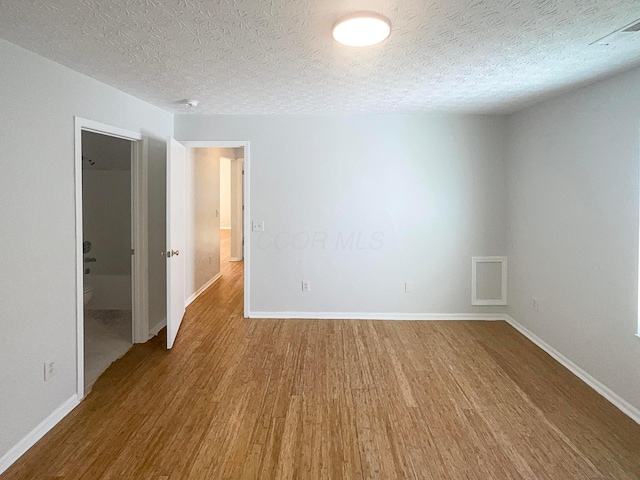 3118 Legion Ln, Columbus, OH 43232 - spare room with wood finished floors, baseboards, and a textured ceiling