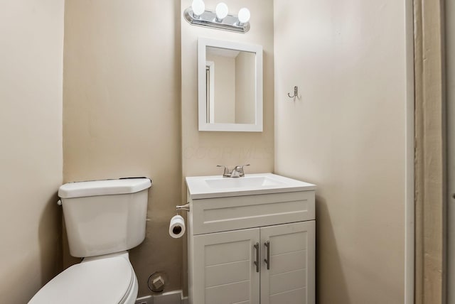 bathroom featuring toilet and vanity