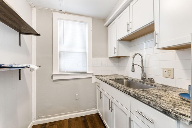 1165 Wager St Unit 1165-1167, Columbus, OH 43206 - kitchen with a sink, dark wood-type flooring, tasteful backsplash, baseboards, and white cabinets